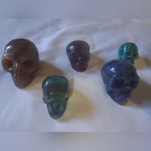 5 Piece Set Of Crystal Skulls Including Madagascar, Sodalite, Rainbow Flourite,